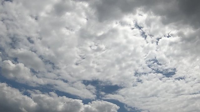 rain clouds coming up to a summer afternoon sky