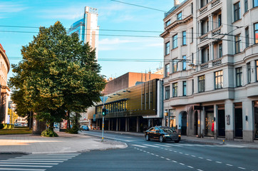 Beautiful empty city with lonely car in middle of the day and with good weather.