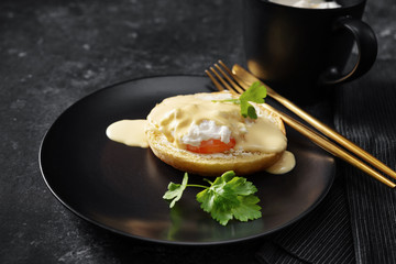 Top view of poached egg in a black plate