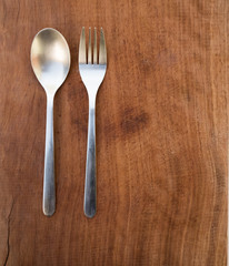 spoon and fork on wooden background