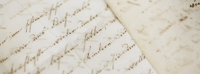 closeup of old handwriting; vintage paper background