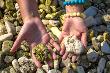 hands holding stones