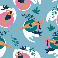 Girls swim and sunbathe in the ocean