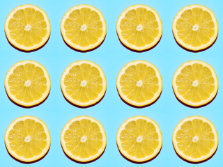 Fruit pattern. Slices of lemon on blue background