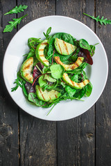 healthy salad grilled avocado and green leaves (vegetarian or diet food) menu concept background. top view. copy space for text