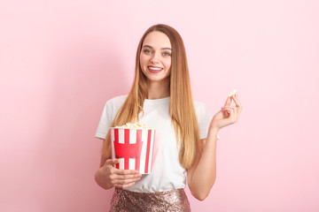 girl with popcorn on a colored background. Watch a movie, 3D movie.