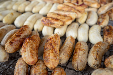 Hot grilled bananas in the outdoor market of Thailand, some focus.