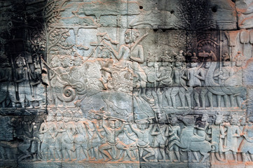 12th century bas-relief with huge army of Khmer kingdome going to war, inside the Bayon temple, Cambodia. Historical artwork on wall of Southeast Asian landmark. UNESCO world heritage site in Angkor