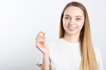 A young girl takes omega-3 capsules. Health Care, Nutritional Supplements