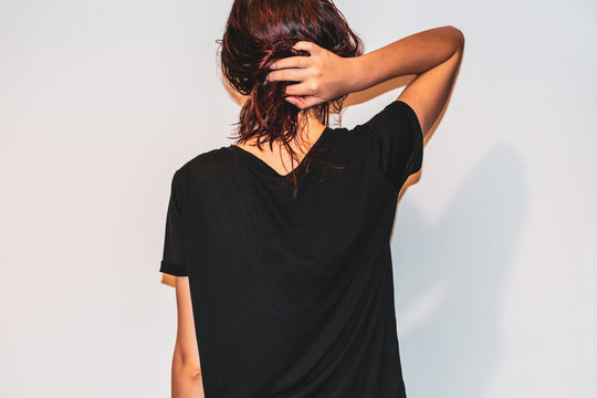 A Back View Shot Of A Young Caucasian Woman Holding Her Wet Messy Red Hair In A Bun After A Shower