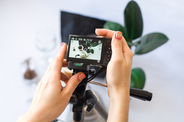 Recording video on the camera on tripod of coffee preparation process on white background.