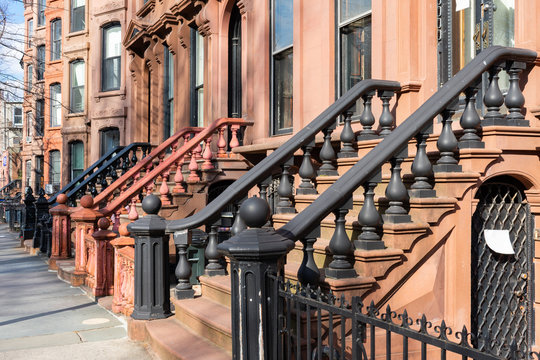 A Row of Old Colorful Brownstone Townhouses with Stairs in Fort Greene Brooklyn New York