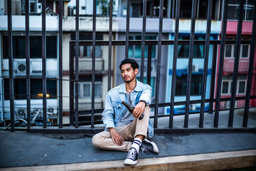 Asian unemployed men stressed after after getting fired or lay off from economics crisis of Coronavirus or Covid-19 epidemic, heartbroken depressed drunk man holding beer alcohol bottle sit on floor 