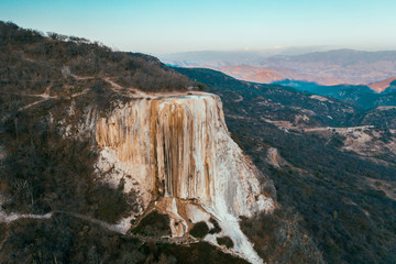 Girl on top of a white mountain with blue lakes and springs hierve del agua