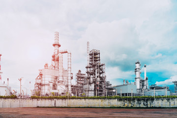 Fototapeta na wymiar Oil refinery plant, power plant on blue sky background.