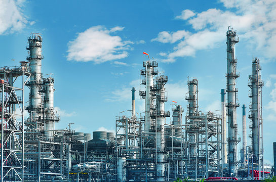 Oil and gas industrial, Oil refinery plant from industry, Refinery Oil storage tank and pipe line steel with blue sky and white clouds background.