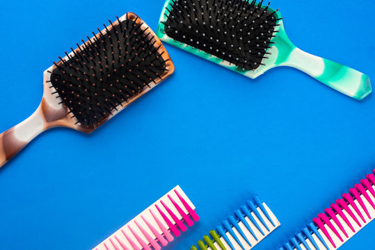 on a blue background are combs and hair clips, hairdressing accessories, top view