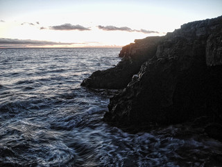 Fototapeta na wymiar Rocks at the coast, sunset, Long exposure, calm mood, relaxing water