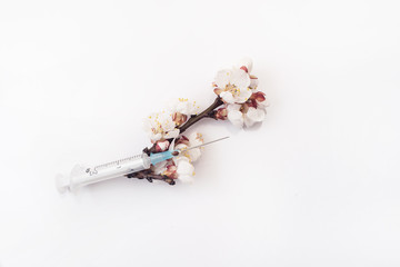 Composition of flowering apricot branch and medical syringe