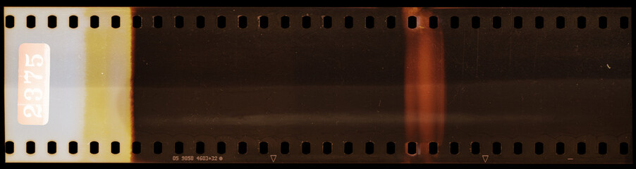 Start of 35mm negative filmstrip, real scan of film material with cool scanning light interferences...