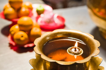 candle floating on oil and offering in a temple in Kuala Lumpur, Malaysia