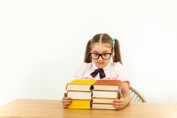 education and school concept - smiling little student girl with many books at school
