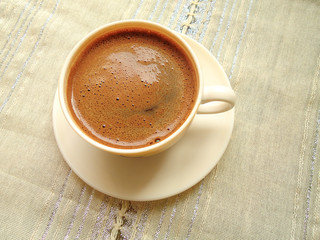 cup of coffee on style tablecloth