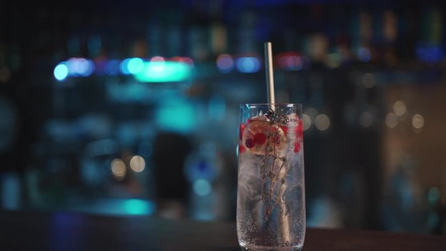 bartender mixing modern gin tonic cocktail with ice