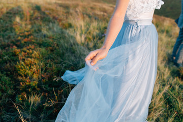 Fototapeta na wymiar Brides hand holding beautiful wedding dress lace