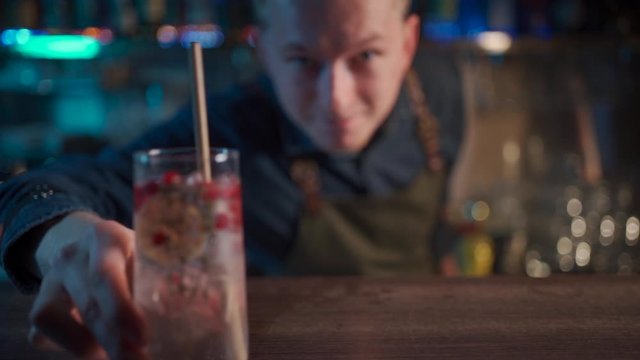 bartender mixing modern gin tonic cocktail with ice