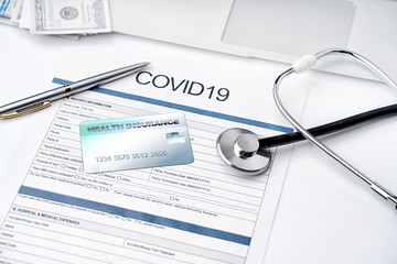 Coronavirus or COVID19 insurance policy document and Stethoscope,Insurance Health care card on desk, Health Care Insurance Plan concept.