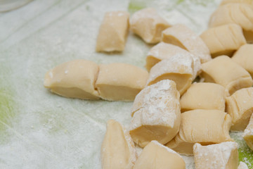 Fototapeta na wymiar Pieces of dough before cooking homemade dumplings at home
