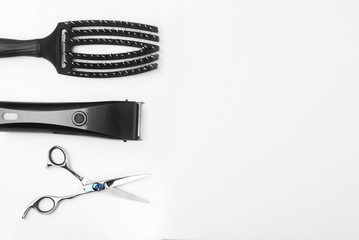 scissors, hair clipper and combs on white background.