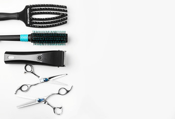 scissors, hair clipper and combs on white background.