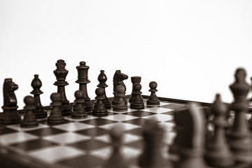 Chess pieces lined up on the chessboard. Concept picture concerning decision making and strategy. Black and white.