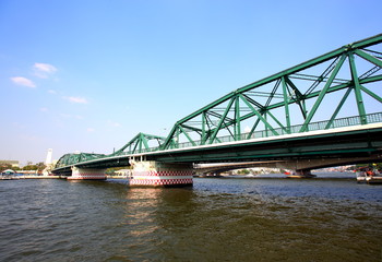 A beautiful old green bridge with steel structures.