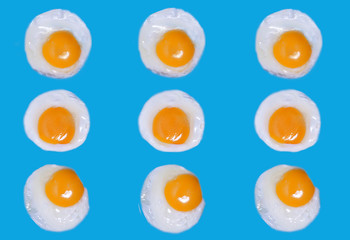 fried eggs on a blue background