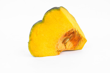 A piece of fresh yellow ripe pumpkin isolated in a middle of a white background