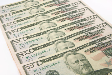 Stack of american money, fifty dollar cash banknotes on white background