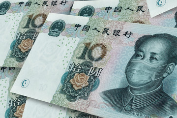 COVID-19 coronavirus in China. Background from Chinese notes at 10 yuan, close up. Background on the theme of coronovirus and the global financial crisis. Medical mask or surgical mask on chines money