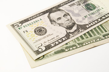Five dollar bills in cash on white background