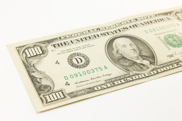 One hundred dollar cash banknotes on white background
