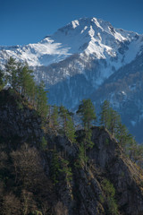 Winter mountain snow peak forest view. Beautiful landscape of mountain ranges of the Caucasus Mountains in the Krasnaya Polyana region of Sochi, Russia