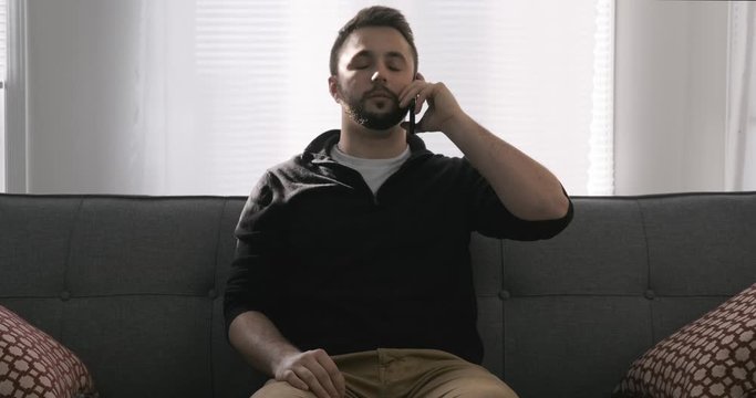 Attractive Young Man Hanging Up A Phone Conversation On A Cell Phone