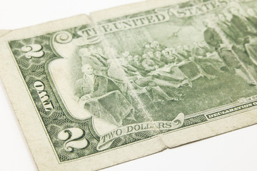 Two dollar bills in cash on white background