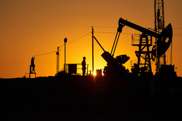 Oil pump oil rig energy industrial machine for petroleum in the sunset background for design.