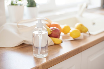 Textile Tote Bag Filled With Fresh Fruits On The Kitchen Counter, Near The Kitchen Sink, Ready To Be Washed. Detergent And Protective Gloves. Corona Virus Prevention. Hygiene To Stop Coronavirus