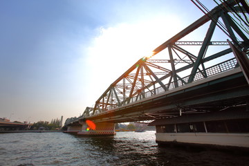 A beautiful old green bridge with steel structures in the evening.
