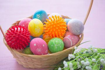 Virus model of Coronavirus disease COVID-19 with colorful easter eggs in basket with flowers on a wooden table background