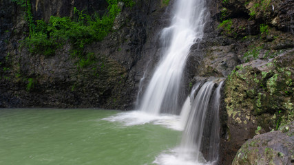 Fototapeta na wymiar Cliffs with soft waterfalls in the hills